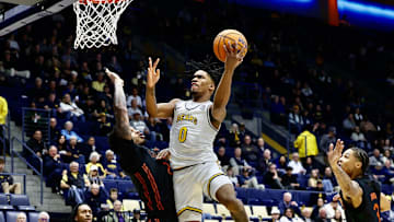 Jeremiah Wilkinson drive for two of his 30 points.