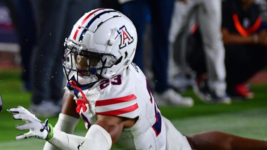 Oct 7, 2023; Los Angeles, California, USA; Southern California Trojans quarterback Caleb Williams (13) scores on the two point conversion during the third overtime ahead of Arizona Wildcats cornerback Tacario Davis (23) at Los Angeles Memorial Coliseum