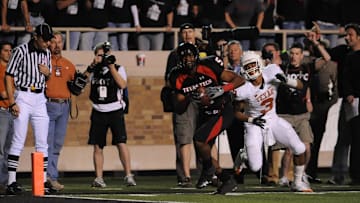 November 1, 2008; Lubbock, TX, USA; Texas Tech Red Raiders wide receiver Michael Crabtree (5) breaks free from Texas Longhorns corner back Curtis Brown (3) to score the game winning touchdown in the fourth quarter at Jones AT&T Stadium. Texas Tech beat Texas 39-33. Mandatory Credit: Brendan Maloney-Imagn Images