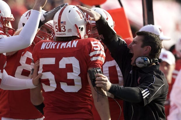 Nebraska Cornhuskers linebackers coach Mike Ekeler (right) celebrates with Tyler Wortman (53).