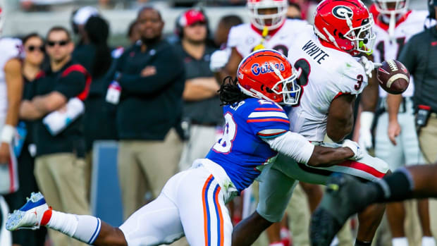 Ty'Ron Hopper (28) strips the ball from Georgia Bulldogs running back Zamir White (3)