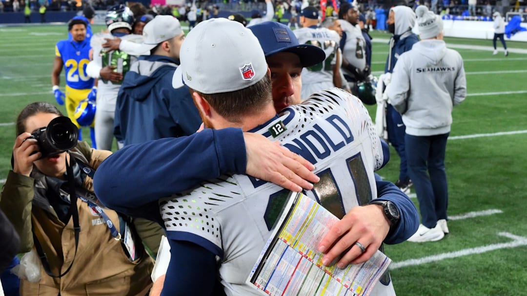 Dec 18, 2025; Seattle, Washington, USA; Seattle Seahawks quarterback Sam Darnold (14) hugs offensive coordinator Klint Kubiak after defeating the Los Angeles Rams in overtime at Lumen Field. 