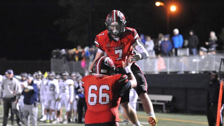 North Quincy's Nate Sampson, top, celebrates his touchdown with teammate Brody Baker during high school football action against Malden Catholic at Veterans Memorial Stadium in Quincy, Friday, Sept. 23, 2022.

Qcy Nqmaldencathfball 8tg