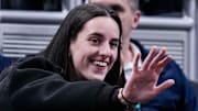 Indiana Fever guard Caitlin Clark (22) waves to her former teammates Wednesday, March 5, 2025, in a round one game at the 2025 TIAA Big Ten Women's Basketball Tournament between the Iowa Hawkeyes and the Wisconsin Badgers at Gainbridge Fieldhouse in Indianapolis.