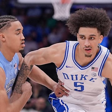 Mar 14, 2025; Charlotte, NC, USA; Duke Blue Devils guard Tyrese Proctor (5) goes to the basket against North Carolina Tar Heels guard Seth Trimble (7) during the second half at Spectrum Center. Mandatory Credit: Jim Dedmon-Imagn Images