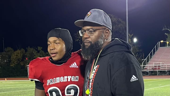 Princeton head coach Andre Parker, right, and his son Andre Parker, Jr., a sophomore, after Princeton beat Sycamore Oct. 20, 2023.