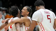 Houston's LJ Cryer (left) and Milos Uzan share a hug following the Cougars' 69-50 win against Tennessee in the Midwest Regional championship game on March 30, 2025.