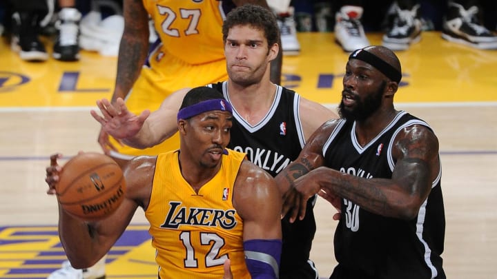 November 20, 2012; Los Angeles, CA, USA;   Brooklyn Nets center Brook Lopez (11) and power forward Reggie Evans (30) guard Los Angeles Lakers center Dwight Howard (12) in the second half of the game at the Staples Center. Lakers won 95-90. Mandatory Credit: Jayne Kamin-Oncea-USA TODAY Sports