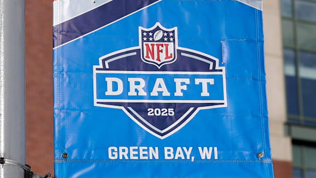 A banner advertising the 2025 NFL Draft is on display in the parking lot of Lambeau Field.