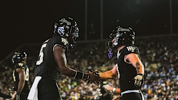 Nov 15, 2025; Winston-Salem, North Carolina, USA; Wake Forest Demon Deacons quarterback Deshawn Purdie (5) and wide receiver Carlos Hernandez (8) celebrate after a play against the North Carolina Tar Heels at Allegacy Federal Credit Union Stadium. Mandatory Credit: Wake Forest Athletics via Imagn Images