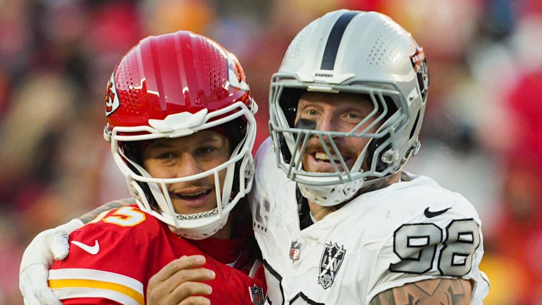 Nov 29, 2024; Kansas City, Missouri, USA; Kansas City Chiefs quarterback Patrick Mahomes (15) and Las Vegas Raiders defensive end Maxx Crosby (98) embrace during the second half at GEHA Field at Arrowhead Stadium. Mandatory Credit: Jay Biggerstaff-Imagn Images