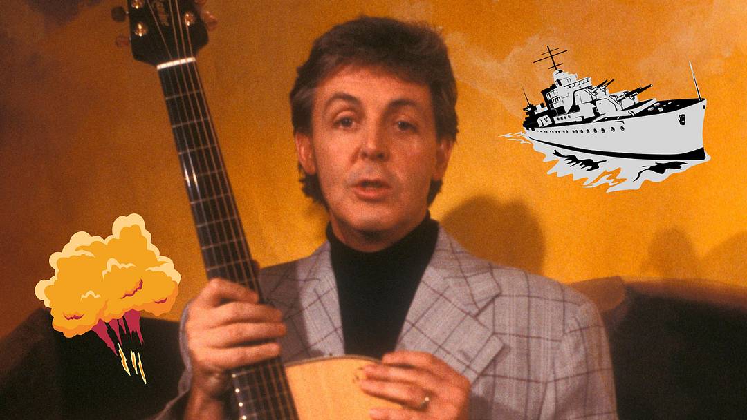 Paul McCartney with atomic bomb and World War II ship next to him