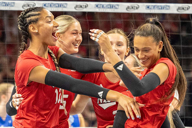 Nebraska players celebrate a point against No. 18 Creighton.