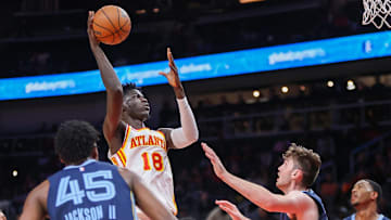 Oct 12, 2023; Atlanta, Georgia, USA; Atlanta Hawks forward Mouhamed Gueye (18) shoots over Memphis Grizzlies forward Matthew Hurt (20) in the first half at State Farm Arena. Mandatory Credit: Brett Davis-Imagn Images