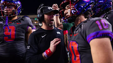 TCU offensive coordinator and associate head coach Kendal Briles talks to quarterback Josh Hoover (10) before the Frogs take the field for an offensive series.