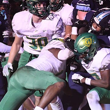 Hoggard's Tamear Webb fights for yards as Hoggard took on Cardinal Gibbons in a 4A semifinal Friday, Dec. 1, 2023, at Hoggard's Scott Braswell Stadium in Wilmington, N.C.