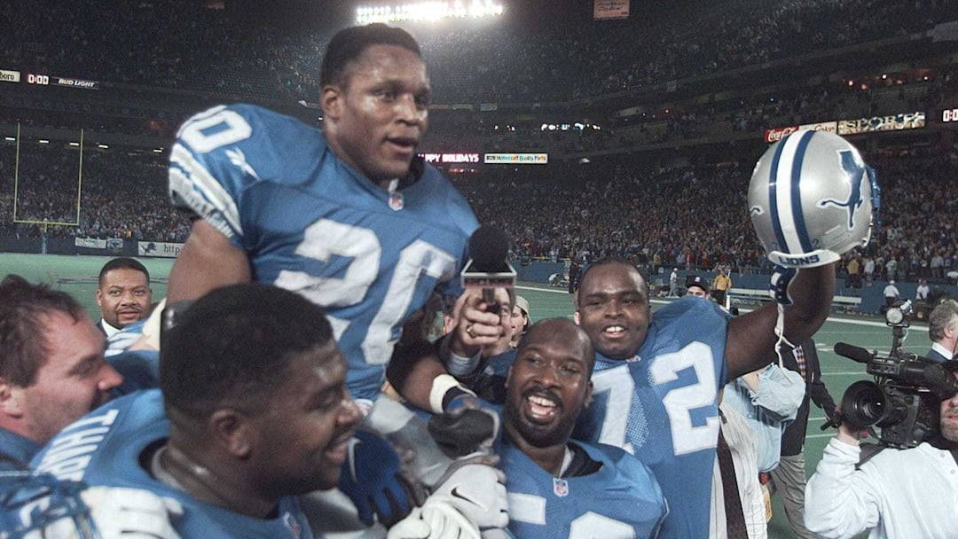 Detroit Lions running back Barry Sanders is carried on the shoulders of teammates after reaching the 2,000-yard milestone in 1997.