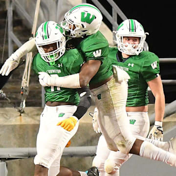 Weddington's #0 TJ Davis took the ball in for a touchdown after a blocked punt as Hoggard took on Weddington High School in the 4A Football Championship at Carter-Finley Stadium in Raleigh Saturday Dec. 9, 2023. Weddington beat Hoggard 56 -21 to win the State Championship. KEN BLEVINS/STARNEWS