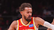 Atlanta Hawks guard Trae Young drives past Toronto Raptors forward Scottie Barnes in the first quarter at State Farm Arena.