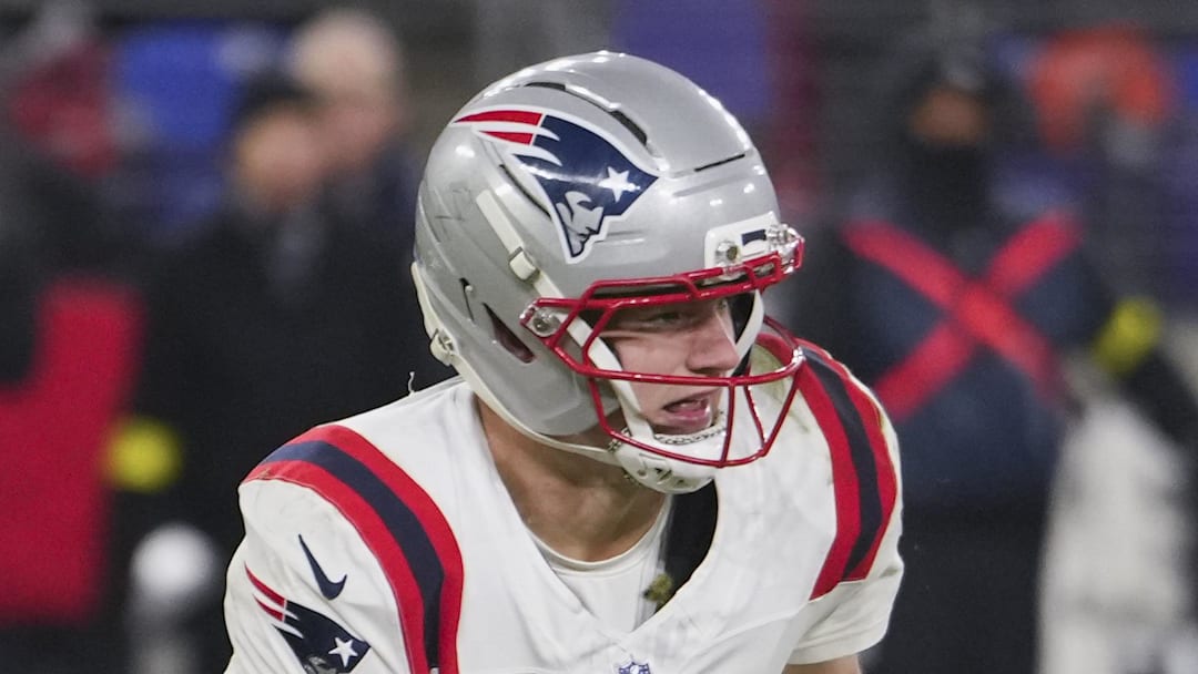 New England Patriots quarterback Drake Maye scrambles against Baltimore Ravens safety Alohi Gilman.