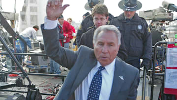 Lee Corso leaves the set of ESPN College GameDay is a weekly television program that airs during the college football season. The hosts are Kirk Herbstreit, Lee Corso, and Chris Fowler. The production was in Fayetteville, Arkansas Nov. 12 for the Arkansas/Tennessee game.