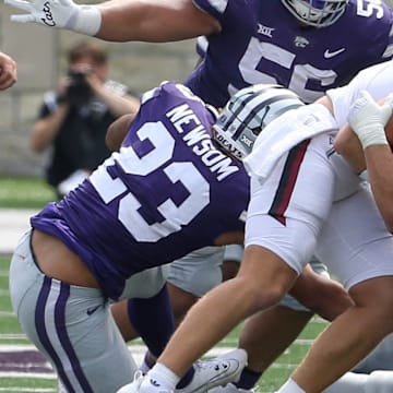 Sep 9, 2023; Manhattan, Kansas, USA; Troy Trojans quarterback Goose Crowder (9) is tackled by Kansas State Wildcats linebacker Austin Romaine (45), defensive tackle Damian Ilalio (56) and linebacker Asa Newsom (23) during the fourth quarter at Bill Snyder Family Football Stadium. Mandatory Credit: Scott Sewell-Imagn Images
