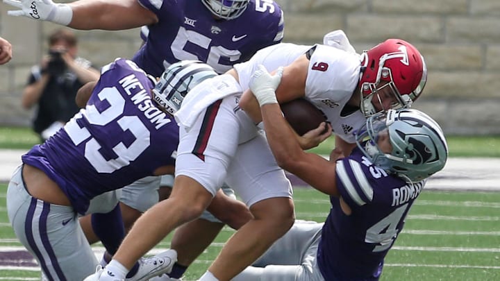 Sep 9, 2023; Manhattan, Kansas, USA; Troy Trojans quarterback Goose Crowder (9) is tackled by Kansas State Wildcats linebacker Austin Romaine (45), defensive tackle Damian Ilalio (56) and linebacker Asa Newsom (23) during the fourth quarter at Bill Snyder Family Football Stadium. Mandatory Credit: Scott Sewell-Imagn Images Sep 9, 2023; Manhattan, Kansas, USA; Troy Trojans quarterback Goose Crowder (9) is tackled by Kansas State Wildcats linebacker Austin Romaine (45), defensive tackle Damian Ilalio (56) and linebacker Asa Newsom (23) during the fourth quarter at Bill Snyder Family Football Stadium. Mandatory Credit: Scott Sewell-Imagn Images