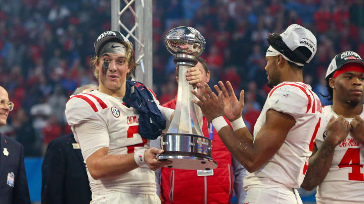 Dec 30, 2023; Atlanta, GA, USA; Mississippi Rebels quarterback Jaxson Dart (2) holds up the Peach Bowl trophy after a victory against the Penn State Nittany Lions at Mercedes-Benz Stadium. Mandatory Credit: Brett Davis-USA TODAY Sports
