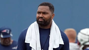Patriots head coach Jerod Mayo looks over his team as he moves across the practice fields.
