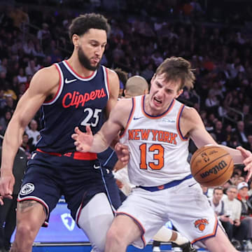 Mar 26, 2025; New York, New York, USA;  New York Knicks guard Tyler Kolek (13) looks to drive past LA Clippers guard Ben Simmons (25) in the third quarter at Madison Square Garden. Mandatory Credit: Wendell Cruz-Imagn Images