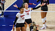 Andi Jackson (15) and Taylor Landfair (12) celebrate a Husker point. 