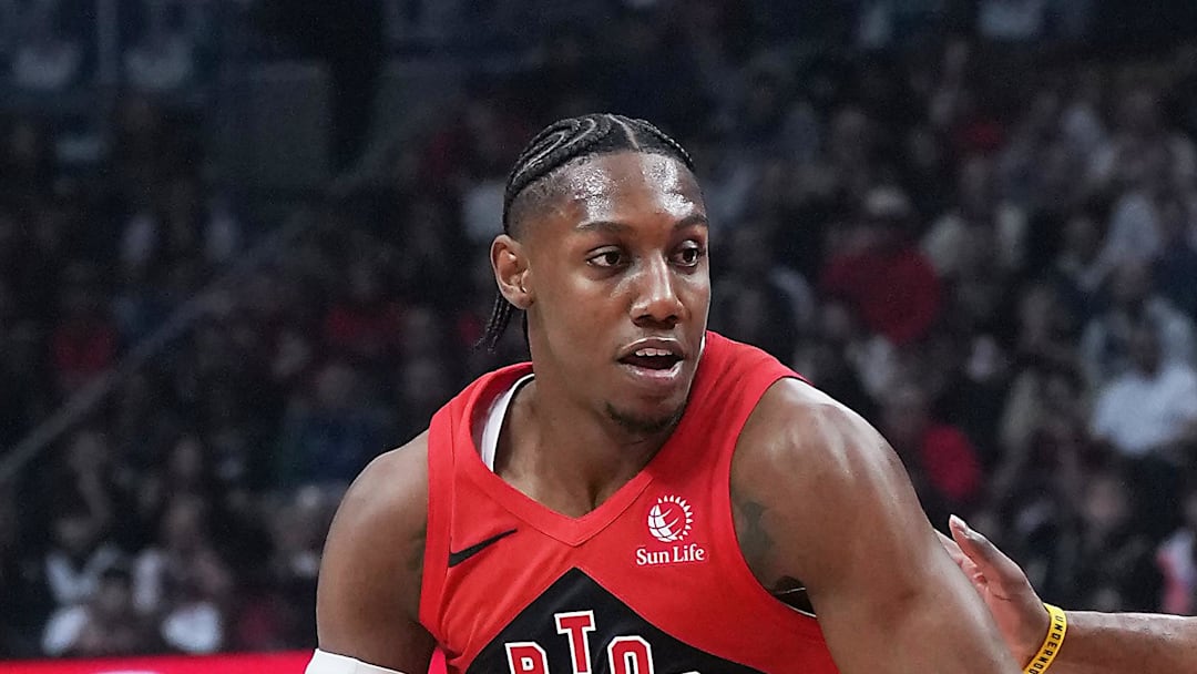 Toronto Raptors forward RJ Barrett controls the ball as  Cleveland Cavaliers guard James Harden tries to defend.