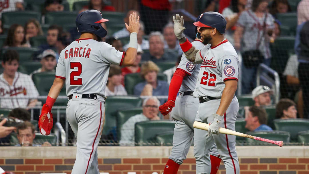 Sep 29, 2023; Atlanta, Georgia, USA; Washington Nationals second baseman Luis Garcia (2) celebrates after scoring with first baseman Dominic Smith (22) against the Atlanta Braves in the fourth inning at Truist Park.