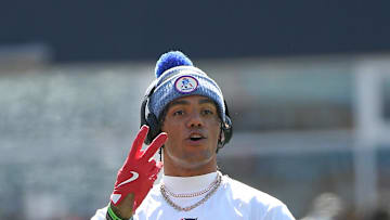 Sep 28, 2025; Foxborough, Massachusetts, USA;  New England Patriots cornerback Christian Gonzalez (0) signals to a teammate during warmups prior to a game against the Carolina Panthers at Gillette Stadium. Mandatory Credit: Bob DeChiara-Imagn Images