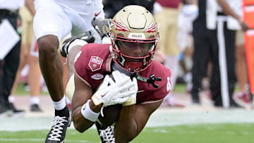 Aug 30, 2025; Tallahassee, Florida, USA; Florida State Seminoles wide receiver Squirrel White (4) makes a catch against Alabama Crimson Tide defensive back Dijon Lee Jr. (5) during the first half at Doak S. Campbell Stadium. Mandatory Credit: Melina Myers-Imagn Images