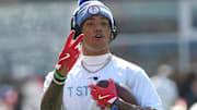 Sep 28, 2025; Foxborough, Massachusetts, USA;  New England Patriots cornerback Christian Gonzalez (0) signals to a teammate during warmups prior to a game against the Carolina Panthers at Gillette Stadium. Mandatory Credit: Bob DeChiara-Imagn Images