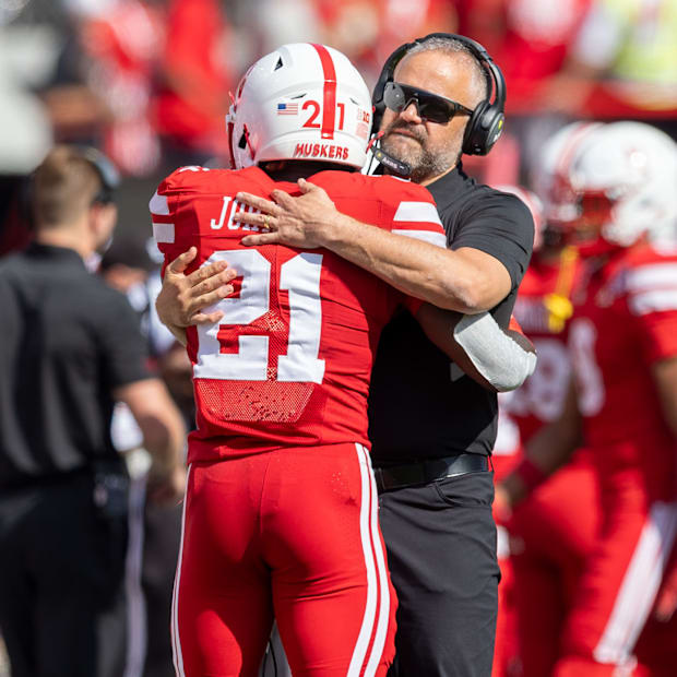 Nebraska coach Matt Rhule and running back Emmett Johnson embrace before a game against Houston Christian.