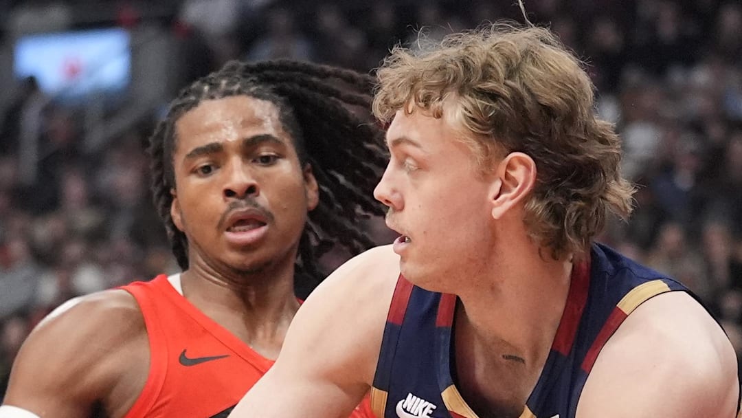 Cleveland Cavaliers forward Luke Travers passes the ball as Toronto Raptors forward Collin Murray-Boyles defends.