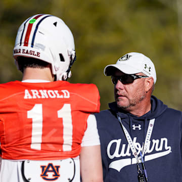 Auburn Tigers head coach Hugh Freeze works with new quarterback Jackson Arnold at spring practice.