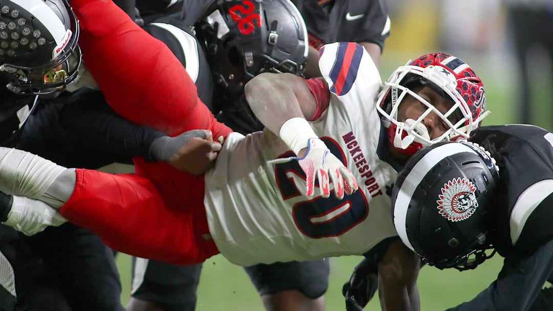 McKeesport's Kemon Spell (20) gets taken to the ground by multiple Aliquippa defenders during the second half of the WPIAL 4A Championship game Friday evening at Acrisure Stadium in Pittsburgh, PA. McKeesport's Kemon Spell (20) gets taken to the ground by multiple Aliquippa defenders during the second half of the WPIAL 4A Championship game Friday evening at Acrisure Stadium in Pittsburgh, PA.