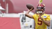 Jun 5, 2024; Ashburn, VA, USA; Washington Commanders quarterback Jayden Daniels (5) passes the ball during OTA workouts at Commanders Park. Mandatory Credit: Geoff Burke-USA TODAY Sports