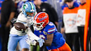 Tulane Green Wave safety Javion White (12) breaks up a pass intended for Florida Gators wide receiver Elijhah Badger (6) during the second half at Raymond James Stadium in Tampa, FL on Friday, December 20, 2024 in the 2024 Union Home Mortgage Gasparilla Bowl. The Gators defeated Tulane 33-8.