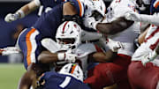 Sep 20, 2025; Charlottesville, Virginia, USA; Stanford Cardinal running back Micah Ford (20) is tackled by Virginia Cavaliers linebacker James Jackson (1) while carrying the ball on a fourth down conversion during the fourth quarter at Scott Stadium. Mandatory Credit: Geoff Burke-Imagn Images
