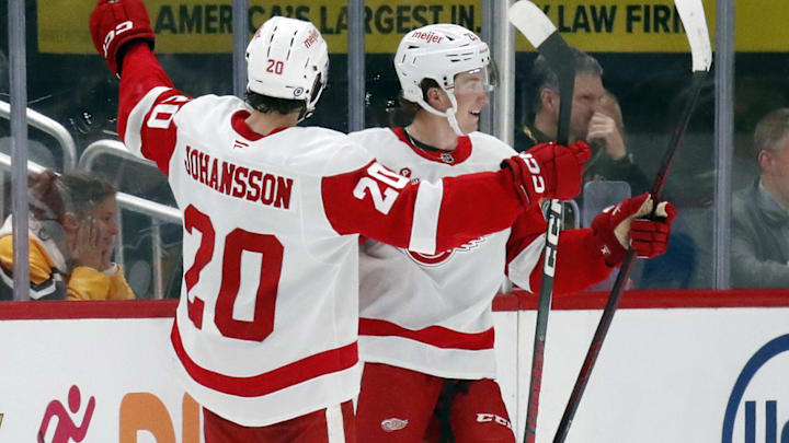 Oct 1, 2024; Pittsburgh, Pennsylvania, USA;  Detroit Red Wings center Nate Danielson (right) celebrates with defenseman Albert Johansson (20) after scoring a goal against the Pittsburgh Penguins during the third period at PPG Paints Arena. Detroit won 2-1. Mandatory Credit: Charles LeClaire-Imagn Images