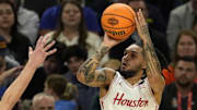 Houston Cougars guard Emanuel Sharp (21) shoots the ball over Florida Gators forward Thomas Haugh (10) during the second half in the national championship game of the Final Four of the 2025 NCAA Tournament at the Alamodome.