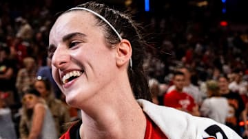 Indiana Fever guard Caitlin Clark smiles in an interview after becoming the first rookie to achieve a triple-double.