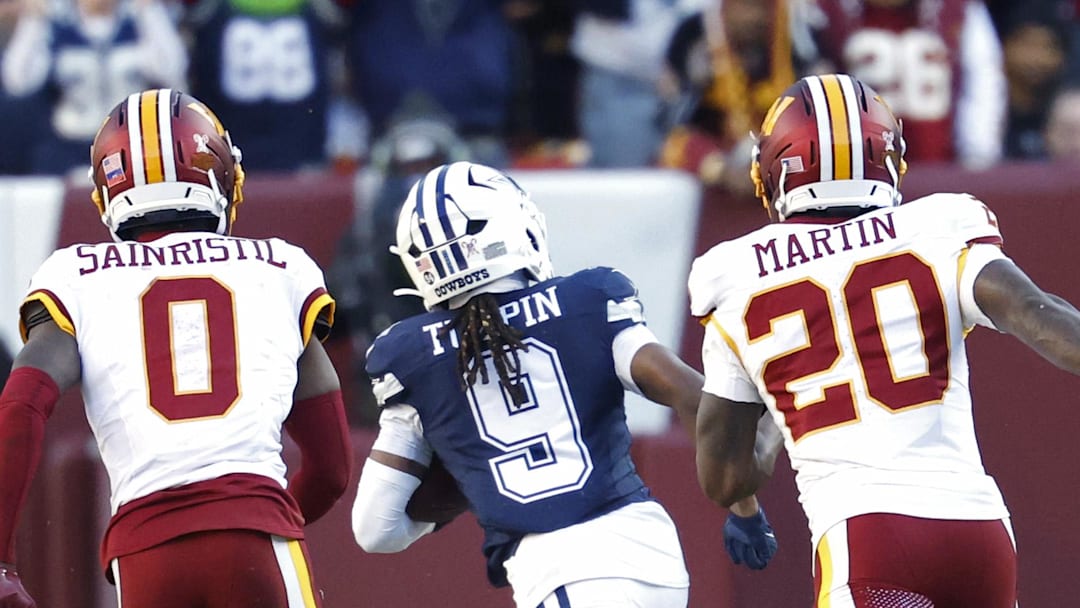 Dec 25, 2025; Landover, Maryland, USA; Dallas Cowboys wide receiver Kavontae Turpin (9) runs with the ball after making a catch en route to a touchdown as Washington Commanders cornerback Mike Sainristil (0) and Commanders safety Quan Martin (20) chase during the first half at Northwest Stadium. Mandatory Credit: Geoff Burke-Imagn Images