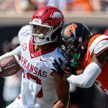 Arkansas Razorbacks quarterback Taylen Green (10) is hit by Oklahoma State Cowboys linebacker Jeff Roberson (22) during the third quarter at Boone Pickens Stadium.