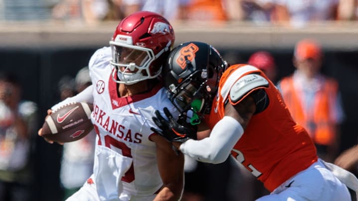 Arkansas Razorbacks quarterback Taylen Green (10) is hit by Oklahoma State Cowboys linebacker Jeff Roberson (22) during the third quarter at Boone Pickens Stadium.