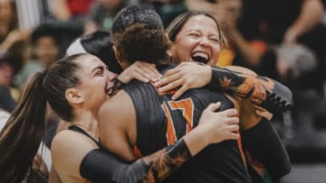 Miami Volleyball players celebrating a win.